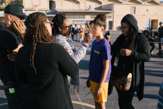 Kim Kimble (right) touches up star Storm Reid (second right) as director Ava DuVernay (left) and crew members look on.